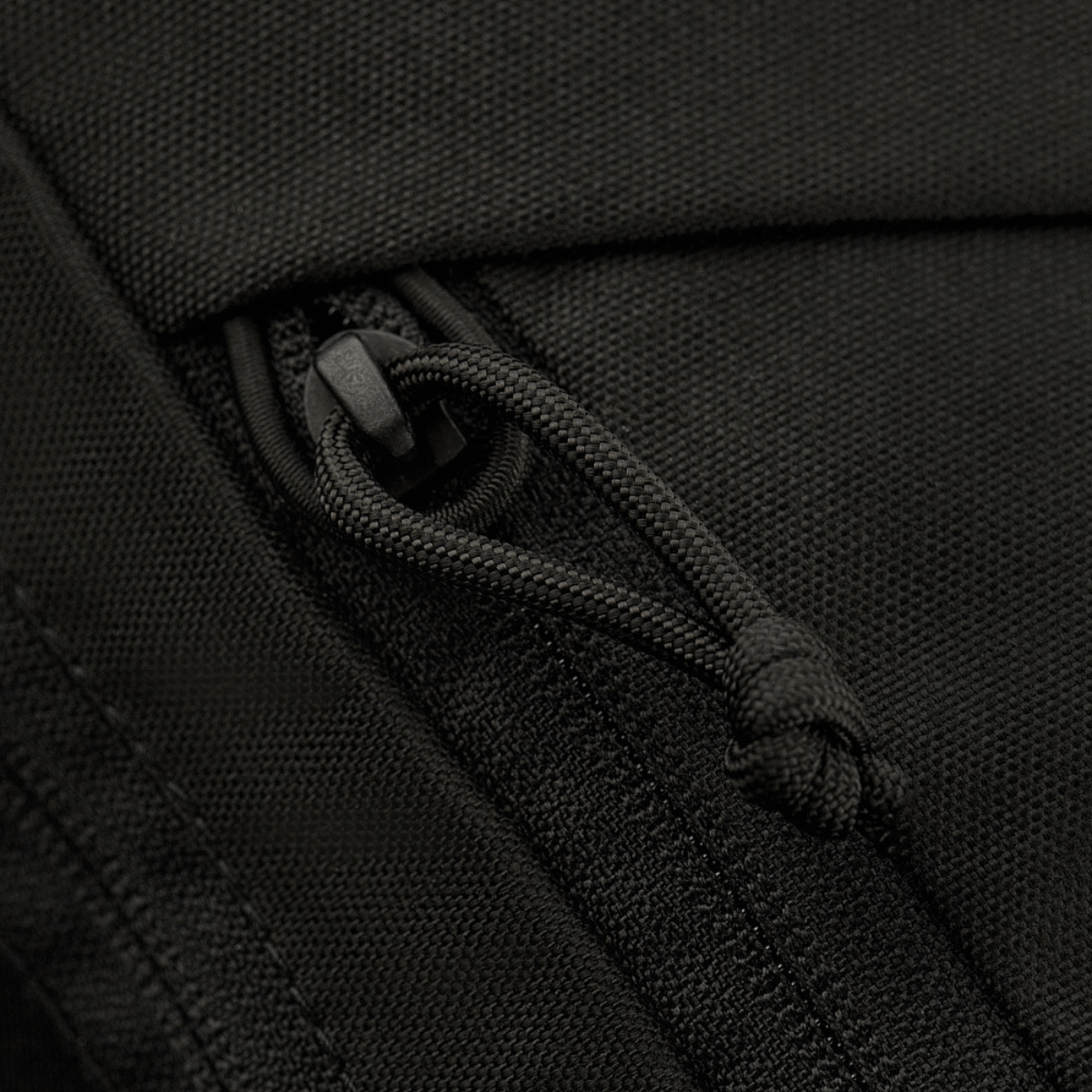 Lähikuva vetoketjusta M-Tac Magnet XL Bag Elite -käytännöllisessä olkalaukussa, jossa innovatiivinen magneettilukko ja tarrapaneeli.