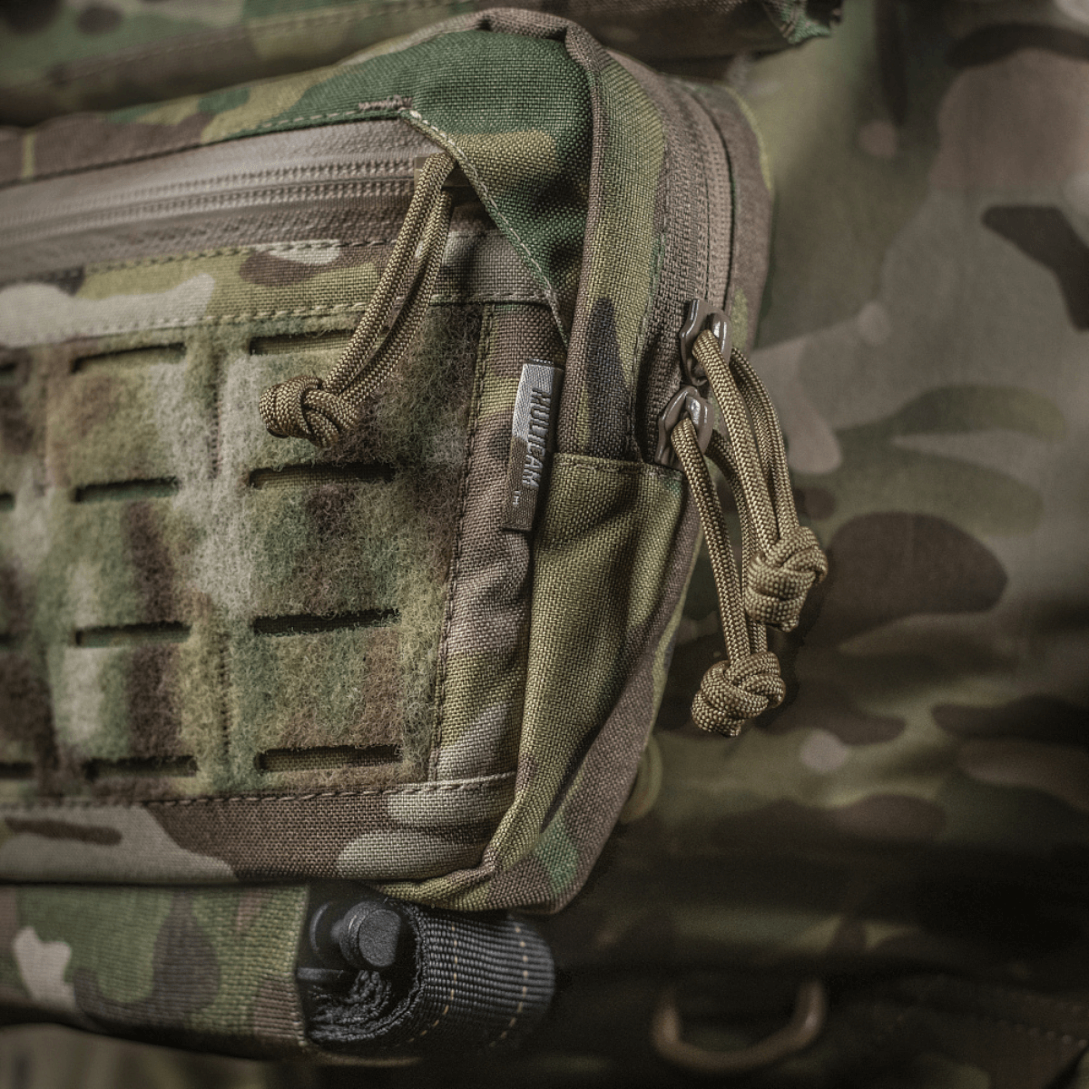 M-Tac Lomme til Tilbehør Lower Large Elite Plate Carrier kestävässä Cordura 500D -materiaalissa, NIJ-sertifiointi, näkymä galleria-asennossa 1, lähikuva vetoketjuista ja materiaalista.