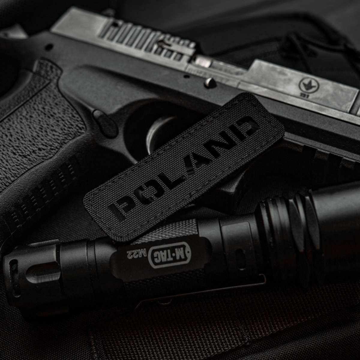 M‑Tac Patch Poland End-to-End 25x80 Cordura 500D:ssä tarrakiinnityksellä ja Laser Cut -kuvioinnilla, näytettynä yhdessä mustan varusteen kanssa.