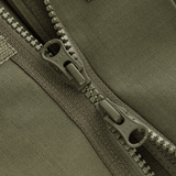 Yksityiskohta M-Tac Patrol Flex -takista kestävästä YKK-vetoketjusta ja Velcro-peitteestä, sopii taktiseen ja käytännölliseen vaatetukseen.