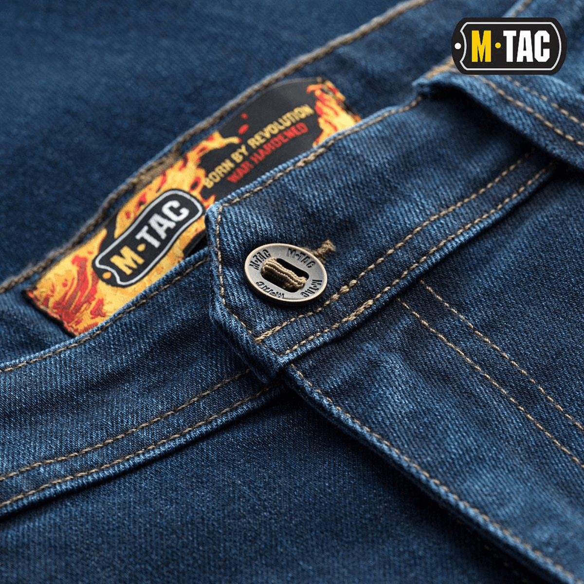 M-Tac Tactical Gen.I Regular Fit -farkut sinisessä denimissä, yksityiskohta napista ja logosta. Sopii taktiseen käyttöön ja arjen mukavuuteen.