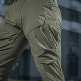 M-Tac Rubicon Flex vedenpitävässä 4-Way Stretch -kankaassa, innovatiivinen cargo-taskusuunnittelu, sopii treeniin ja ulkoaktiviteetteihin.