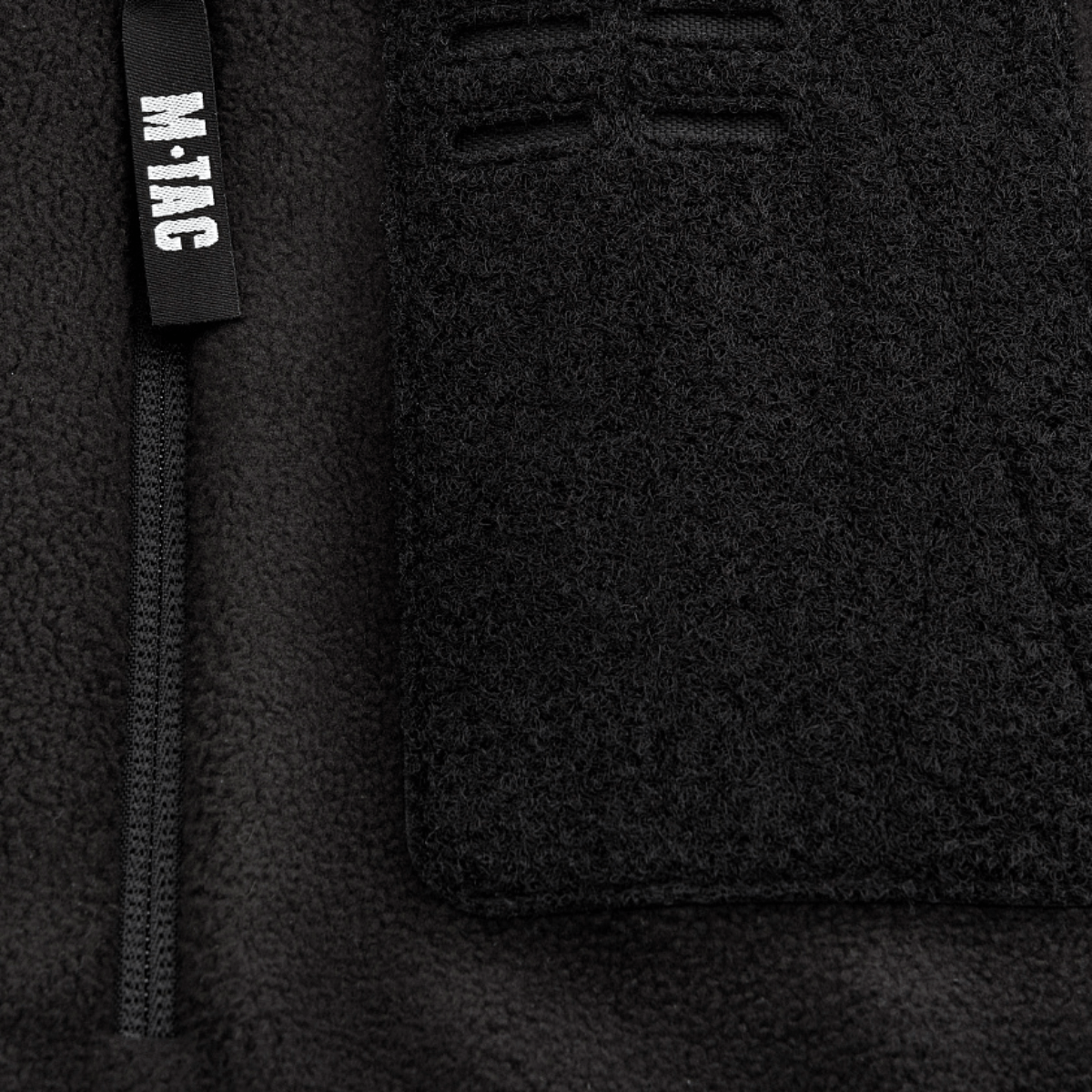 Yksityiskohta M-Tac Alpha Microfleece Jakke Gen.II -takista vahvistetulla fleecellä ja vetoketjulla, täydellinen taktiseen käyttöön kylmällä säällä.