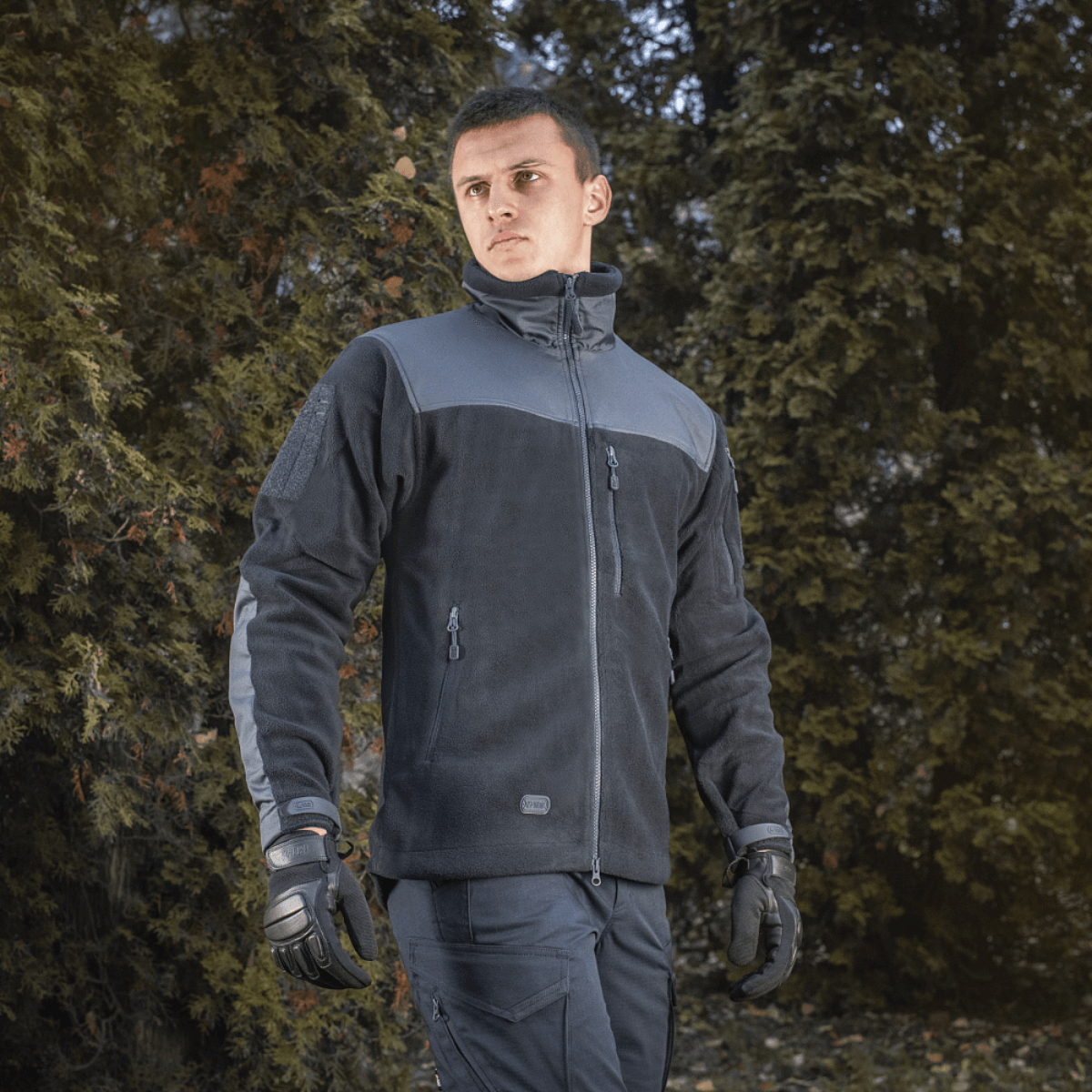 Mies pukeutuneena M-Tac Alpha Microfleece Jakke Gen.II -takkiin, täydellinen taktiseen ja ulkoilukäyttöön kylmällä säällä.