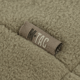 Lähikuva M-Tac Combat Fleece Polartec -takista, tekstiilirakenne ja näkyvä M-Tac-merkki.