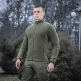 M-Tac Polartec Sport -fleecetakki vihreänä, käytetty ulkona päällyskerroksena vaihtokausina.