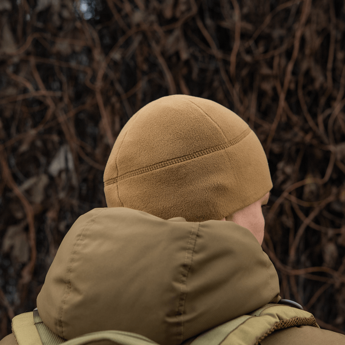 M-Tac Fleece Watch Cap Light Polartec talvihattu käytössä, nähtynä takaa, pidetään päällysvaatteiden alla, korostaa pehmeää Polartec-fleeceä.
