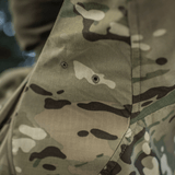 M-Tac-takki Sturm Gen.II NYCO Extreme Multicam. Yksityiskohta kulutusta kestävästä kankaasta, sopii taktiseen käyttöön ja ulkoiluun.