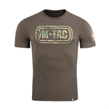 M-Tac T-Shirt Logo modernissa maastokuviossa, ikoninen logo ja slogan 'Born by Revolution – Hardened by War' hihassa.