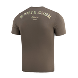 M-Tac T-Shirt Logo, takana maastokuvio ja teksti 'Military & Tactical Since 2014' sekä slogan 'Born by Revolution – Hardened by War'.